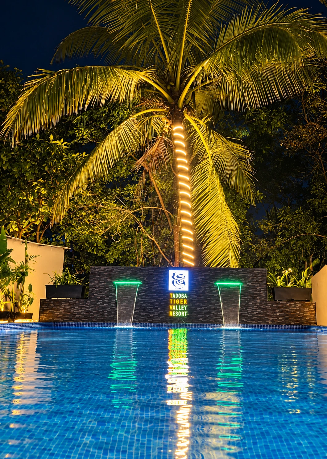 The resort pool at dusk, framed by trees and warm lights